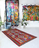 Vintage kilim rug in living room setting, bright colors, wild shaman, soft rug, bold color, Portland, Oregon, rug store, rug shop, local shop, vintage rug, modern kilim, warm colors, antique rug, antique kilim