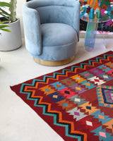 Vintage kilim rug in living room setting, bright colors, wild shaman, soft rug, bold color, Portland, Oregon, rug store, rug shop, local shop, vintage rug, modern kilim, warm colors, antique rug, antique kilim