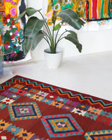 Vintage kilim rug in living room setting, bright colors, wild shaman, soft rug, bold color, Portland, Oregon, rug store, rug shop, local shop, vintage rug, modern kilim, warm colors, antique rug, antique kilim