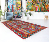 Vintage kilim rug in living room setting, bright colors, wild shaman, soft rug, bold color, Portland, Oregon, rug store, rug shop, local shop, vintage rug, modern kilim, warm colors, antique rug, antique kilim