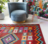Vintage kilim rug in living room setting, bright colors, wild shaman, soft rug, bold color, Portland, Oregon, rug store, rug shop, local shop, vintage rug, modern kilim, warm colors, antique rug, antique kilim