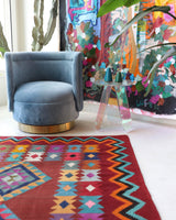 Vintage kilim rug in living room setting, bright colors, wild shaman, soft rug, bold color, Portland, Oregon, rug store, rug shop, local shop, vintage rug, modern kilim, warm colors, antique rug, antique kilim