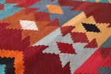 Vintage kilim rug in living room setting, bright colors, wild shaman, soft rug, bold color, Portland, Oregon, rug store, rug shop, local shop, vintage rug, modern kilim, warm colors, antique rug, antique kilim