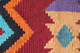 Vintage kilim rug in living room setting, bright colors, wild shaman, soft rug, bold color, Portland, Oregon, rug store, rug shop, local shop, vintage rug, modern kilim, warm colors, antique rug, antique kilim