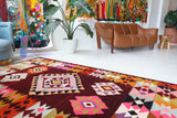 Vintage kilim rug in living room setting, bright colors, wild shaman, soft rug, bold color, Portland, Oregon, rug store, rug shop, local shop, vintage rug, modern kilim, warm colors, antique rug, antique kilim