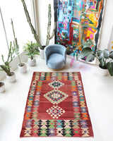 Vintage kilim rug in living room setting, old rug, antique rug, pastel colors, faded colors, Turkish rug, vintage rug, soft rug, Portland, Oregon, rug store, rug shop, local shop, earthy tones, earthy colors, warm colors