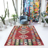 Vintage kilim rug in living room setting, old rug, antique rug, pastel colors, faded colors, Turkish rug, vintage rug, soft rug, Portland, Oregon, rug store, rug shop, local shop, earthy tones, earthy colors, warm colors
