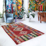 Vintage kilim rug in living room setting, old rug, antique rug, pastel colors, faded colors, Turkish rug, vintage rug, soft rug, Portland, Oregon, rug store, rug shop, local shop, earthy tones, earthy colors, warm colors