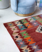 Vintage kilim rug in living room setting, old rug, antique rug, pastel colors, faded colors, Turkish rug, vintage rug, soft rug, Portland, Oregon, rug store, rug shop, local shop, earthy tones, earthy colors, warm colors