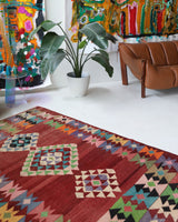 Vintage kilim rug in living room setting, old rug, antique rug, pastel colors, faded colors, Turkish rug, vintage rug, soft rug, Portland, Oregon, rug store, rug shop, local shop, earthy tones, earthy colors, warm colors