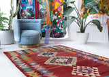 Vintage kilim rug in living room setting, old rug, antique rug, pastel colors, faded colors, Turkish rug, vintage rug, soft rug, Portland, Oregon, rug store, rug shop, local shop, earthy tones, earthy colors, warm colors