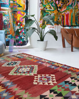 Vintage kilim rug in living room setting, old rug, antique rug, pastel colors, faded colors, Turkish rug, vintage rug, soft rug, Portland, Oregon, rug store, rug shop, local shop, earthy tones, earthy colors, warm colors