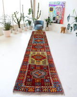 Vintage Turkish runner rug in a living room setting, pile rug, Turkish rug, vintage rug, portland, rug shop, bright colors, wild shaman, soft rug, bold color, Portland, Oregon, rug store, rug shop, local shop, antique rug