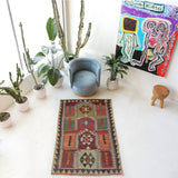 Vintage kilim rug in living room setting, old rug, antique rug, pastel colors, faded colors, Turkish rug, vintage rug, soft rug, Portland, Oregon, rug store, rug shop, local shop, earthy tones, earthy colors, warm colors