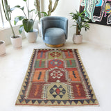 Vintage kilim rug in living room setting, old rug, antique rug, pastel colors, faded colors, Turkish rug, vintage rug, soft rug, Portland, Oregon, rug store, rug shop, local shop, earthy tones, earthy colors, warm colors