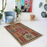 Vintage kilim rug in living room setting, old rug, antique rug, pastel colors, faded colors, Turkish rug, vintage rug, soft rug, Portland, Oregon, rug store, rug shop, local shop, earthy tones, earthy colors, warm colors