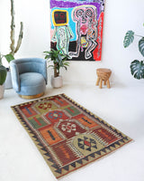 Vintage kilim rug in living room setting, old rug, antique rug, pastel colors, faded colors, Turkish rug, vintage rug, soft rug, Portland, Oregon, rug store, rug shop, local shop, earthy tones, earthy colors, warm colors