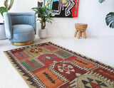 Vintage kilim rug in living room setting, old rug, antique rug, pastel colors, faded colors, Turkish rug, vintage rug, soft rug, Portland, Oregon, rug store, rug shop, local shop, earthy tones, earthy colors, warm colors