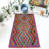 Vintage kilim rug in living room setting, bright colors, wild shaman, soft rug, bold color, Portland, Oregon, rug store, rug shop, local shop, vintage rug, modern kilim, warm colors, antique kilim rug