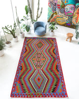 Vintage kilim rug in living room setting, bright colors, wild shaman, soft rug, bold color, Portland, Oregon, rug store, rug shop, local shop, vintage rug, modern kilim, warm colors, antique kilim rug