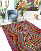 Vintage kilim rug in living room setting, bright colors, wild shaman, soft rug, bold color, Portland, Oregon, rug store, rug shop, local shop, vintage rug, modern kilim, warm colors, antique kilim rug