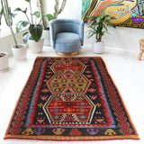 Vintage kilim rug in living room setting, bright colors, wild shaman, soft rug, bold color, Portland, Oregon, rug store, rug shop, local shop, vintage rug, modern kilim, warm colors, antique kilim rug