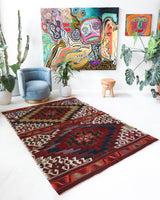 Vintage kilim rug in living room setting, old rug, antique rug, pastel colors, faded colors, Turkish rug, vintage rug, soft rug, Portland, Oregon, rug store, rug shop, local shop, earthy tones, earthy colors, warm colors