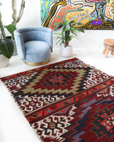 Vintage kilim rug in living room setting, old rug, antique rug, pastel colors, faded colors, Turkish rug, vintage rug, soft rug, Portland, Oregon, rug store, rug shop, local shop, earthy tones, earthy colors, warm colors