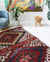 Vintage kilim rug in living room setting, old rug, antique rug, pastel colors, faded colors, Turkish rug, vintage rug, soft rug, Portland, Oregon, rug store, rug shop, local shop, earthy tones, earthy colors, warm colors