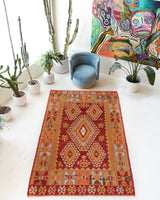 Vintage kilim rug in room decor setting, old rug, antique rug, pastel colors, faded colors, Turkish rug, vintage rug, soft rug, Portland, Oregon, rug store, rug shop, local shop, antique kilim rug, bold colors, bright colors