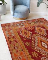 Vintage kilim rug in room decor setting, old rug, antique rug, pastel colors, faded colors, Turkish rug, vintage rug, soft rug, Portland, Oregon, rug store, rug shop, local shop, antique kilim rug, bold colors, bright colors