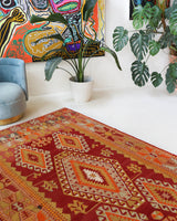 Vintage kilim rug in room decor setting, old rug, antique rug, pastel colors, faded colors, Turkish rug, vintage rug, soft rug, Portland, Oregon, rug store, rug shop, local shop, antique kilim rug, bold colors, bright colors