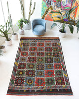 Vintage kilim rug in living room setting, bright colors, wild shaman, soft rug, bold color, Portland, Oregon, rug store, rug shop, local shop, vintage rug, modern kilim, warm colors, antique kilim rug