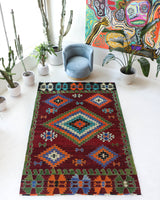Vintage kilim rug in room decor setting, old rug, antique rug, pastel colors, faded colors, Turkish rug, vintage rug, soft rug, Portland, Oregon, rug store, rug shop, local shop, antique kilim rug, bold colors, bright colors, faded colors