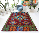 Vintage kilim rug in room decor setting, old rug, antique rug, pastel colors, faded colors, Turkish rug, vintage rug, soft rug, Portland, Oregon, rug store, rug shop, local shop, antique kilim rug, bold colors, bright colors, faded colors