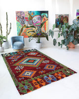 Vintage kilim rug in room decor setting, old rug, antique rug, pastel colors, faded colors, Turkish rug, vintage rug, soft rug, Portland, Oregon, rug store, rug shop, local shop, antique kilim rug, bold colors, bright colors, faded colors