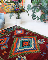 Vintage kilim rug in room decor setting, old rug, antique rug, pastel colors, faded colors, Turkish rug, vintage rug, soft rug, Portland, Oregon, rug store, rug shop, local shop, antique kilim rug, bold colors, bright colors, faded colors