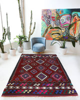 Vintage kilim rug in room decor setting, old rug, antique rug, pastel colors, faded colors, Turkish rug, vintage rug, soft rug, Portland, Oregon, rug store, rug shop, local shop, antique kilim rug, bold colors, bright colors, faded colors