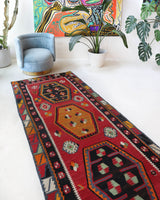 Vintage Turkish runner rug in a living room setting, pile rug, Turkish rug, vintage rug, portland, rug shop, bright colors, wild shaman, soft rug, bold color, Portland, Oregon, rug store, rug shop, local shop
