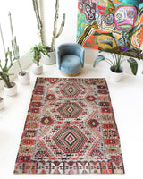 Vintage kilim rug in living room setting, old rug, antique rug, pastel colors, faded colors, Turkish rug, vintage rug, soft rug, Portland, Oregon, rug store, rug shop, local shop, earthy tones, earthy colors, warm colors