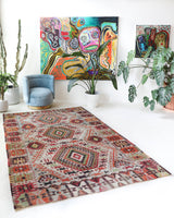 Vintage kilim rug in living room setting, old rug, antique rug, pastel colors, faded colors, Turkish rug, vintage rug, soft rug, Portland, Oregon, rug store, rug shop, local shop, earthy tones, earthy colors, warm colors
