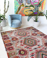 Vintage kilim rug in living room setting, old rug, antique rug, pastel colors, faded colors, Turkish rug, vintage rug, soft rug, Portland, Oregon, rug store, rug shop, local shop, earthy tones, earthy colors, warm colors