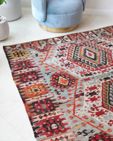 Vintage kilim rug in living room setting, old rug, antique rug, pastel colors, faded colors, Turkish rug, vintage rug, soft rug, Portland, Oregon, rug store, rug shop, local shop, earthy tones, earthy colors, warm colors