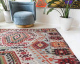 Vintage kilim rug in living room setting, old rug, antique rug, pastel colors, faded colors, Turkish rug, vintage rug, soft rug, Portland, Oregon, rug store, rug shop, local shop, earthy tones, earthy colors, warm colors