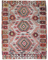 Vintage kilim rug in living room setting, old rug, antique rug, pastel colors, faded colors, Turkish rug, vintage rug, soft rug, Portland, Oregon, rug store, rug shop, local shop, earthy tones, earthy colors, warm colors