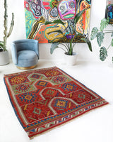 Vintage kilim rug in living room setting, bright colors, wild shaman, soft rug, bold color, Portland, Oregon, rug store, rug shop, local shop, vintage rug, modern kilim, warm colors, antique rug, antique kilim