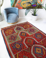 Vintage kilim rug in living room setting, bright colors, wild shaman, soft rug, bold color, Portland, Oregon, rug store, rug shop, local shop, vintage rug, modern kilim, warm colors, antique rug, antique kilim