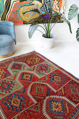 Vintage kilim rug in living room setting, bright colors, wild shaman, soft rug, bold color, Portland, Oregon, rug store, rug shop, local shop, vintage rug, modern kilim, warm colors, antique rug, antique kilim