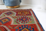 Vintage kilim rug in living room setting, bright colors, wild shaman, soft rug, bold color, Portland, Oregon, rug store, rug shop, local shop, vintage rug, modern kilim, warm colors, antique rug, antique kilim