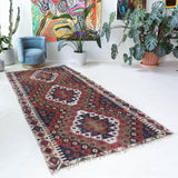 Vintage kilim rug in living room setting, bright colors, wild shaman, soft rug, bold color, Portland, Oregon, rug store, rug shop, local shop, vintage rug, modern kilim, warm colors, antique rug, antique kilim